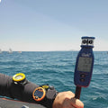 Windie.pro Pin End Kit with anemometer and sailing timer on wrist, used for race management on the water.