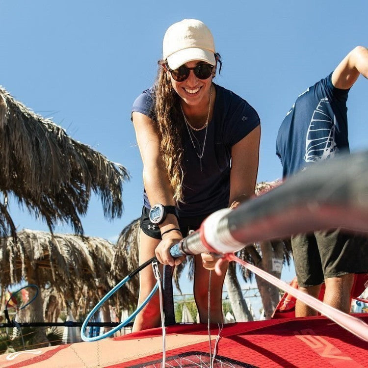 Windie.pro white sailing timer stopwatch worn by a woman on her wrist, ready for a race.
