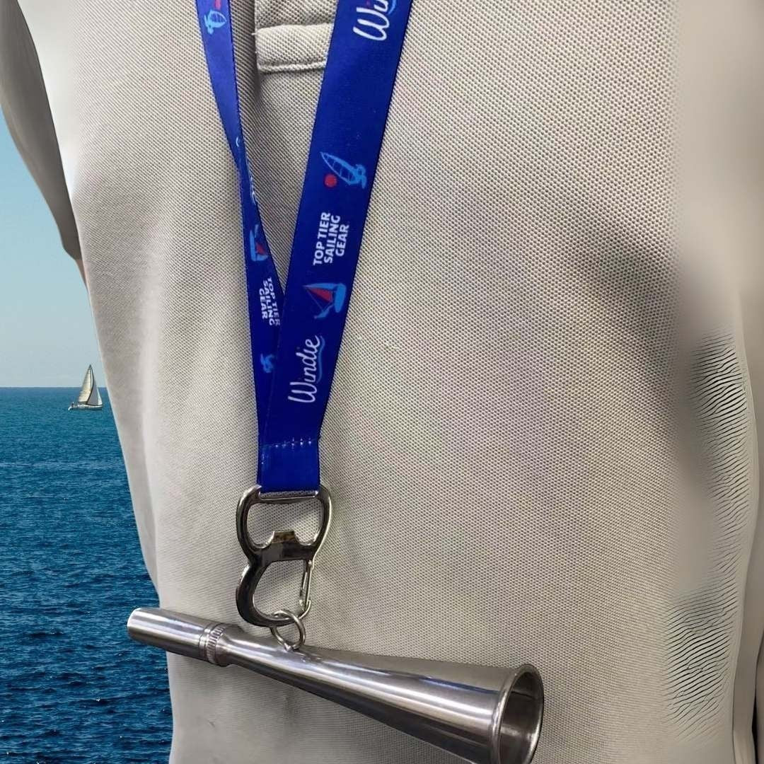 windie.pro stainless steel handheld fog horn, 17cm long, with blue lanyard and sailing graphics.