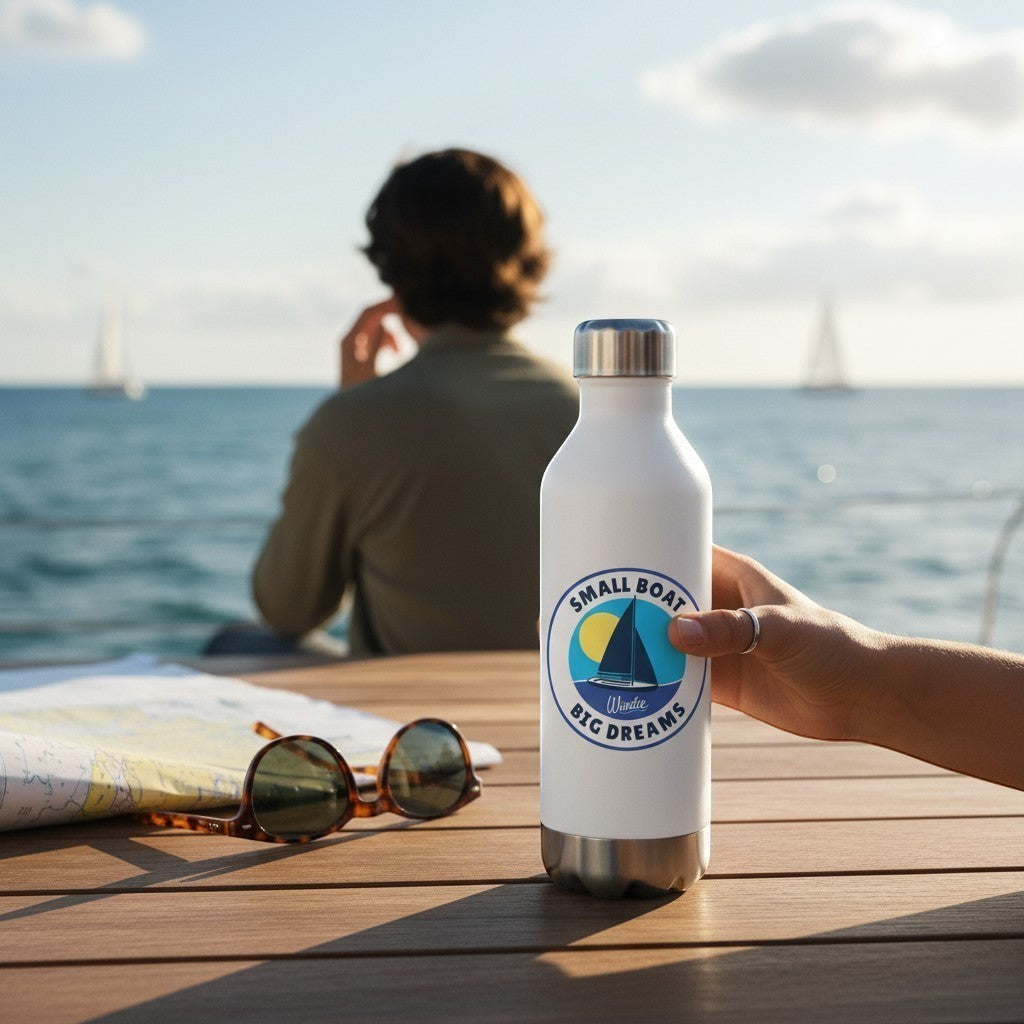 windie.pro waterproof sailing sticker on white water bottle, featuring a sailboat and sun.