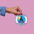 windie.pro round sticker with a sailboat, sun, and text 