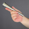 windie.pro stainless steel handheld fog horn, 17cm long, with a loop for attachment, held in a hand against a dark grey background.