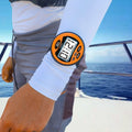 Orange Windie sailing timer stopwatch worn on arm, displaying race time. Ideal for competitive sailing.