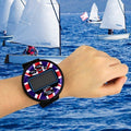 Windie.pro sailing timer watch with Union Jack design on wrist, featuring sync, mode, set, clear, start, and stop buttons. Digital display shows race timing.